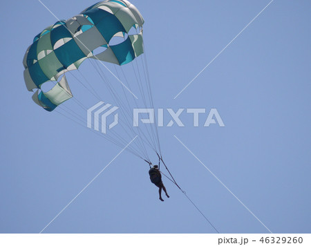 The paratrooper is hovering in the blue skies unde The paratrooper is hovering in the blue skies unde 46329260