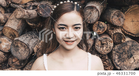 pretty woman smiling on stack of log background pretty woman smiling on stack of log background 46331700