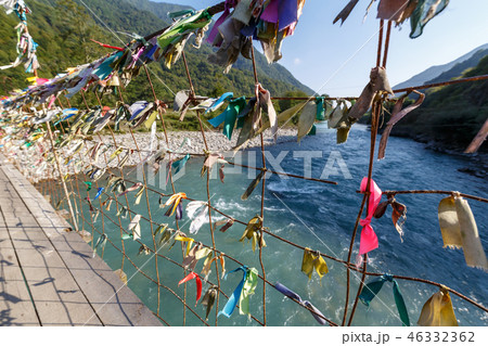 Multicolored ribbons knotted on pedestrian bridge Multicolored ribbons knotted on pedestrian bridge 46332362