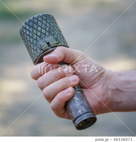 Antitank grenade in the male hand close-up Antitank grenade in the male hand close-up 46336071