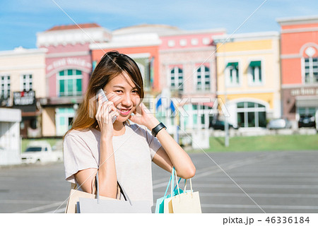 woman using smartphone with shopping bags. woman using smartphone with shopping bags. 46336184