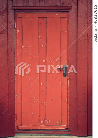 Old wooden red rustic cabin door with antique handle. Norway. Old wooden red rustic cabin door with antique handle. Norway. 46337615