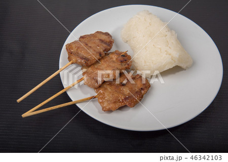 Roast pork with sticky rice on a plate and white  46342103