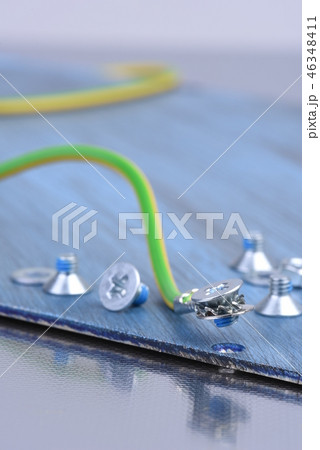 Screw and cable on metallic background close-up Screw and cable on metallic background close-up 46348411
