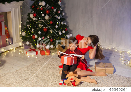 mother and son celebrate the new year Christmas tree gifts mother and son celebrate the new year Christmas tree gifts 46349264