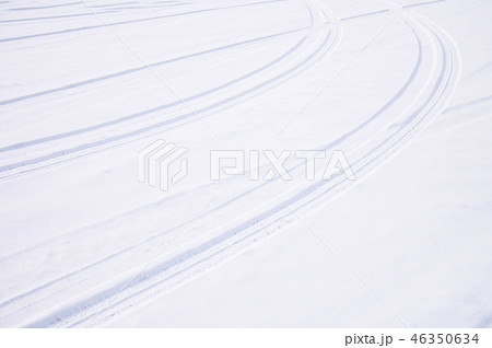 Traces of intersecting arcs of automobile tires in fresh snow 46350634