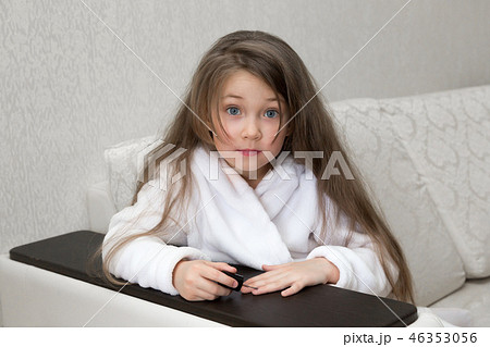 Little Caucasian girl paints nails on hands. Little Caucasian girl paints nails on hands. 46353056