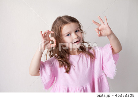 little girl in a pink dress shows hands heart little girl in a pink dress shows hands heart 46353309