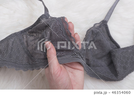 Gray lace bra in female hand. Fashion concept 46354060
