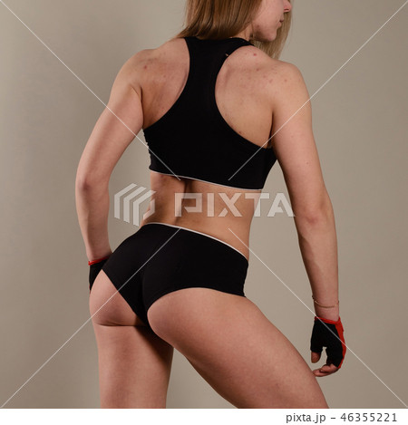 Sporty girl stands with her back in gear.  46355221