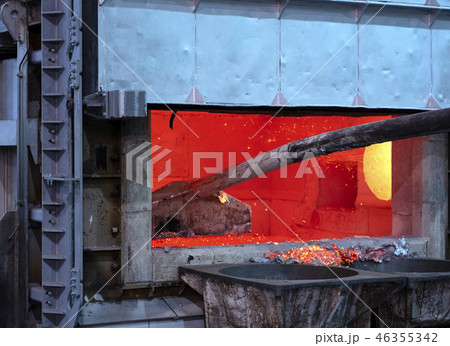 skimming dross on melted aluminum 46355342