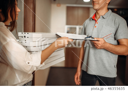 Customer takes order on pizza from delivery man Customer takes order on pizza from delivery man 46355635