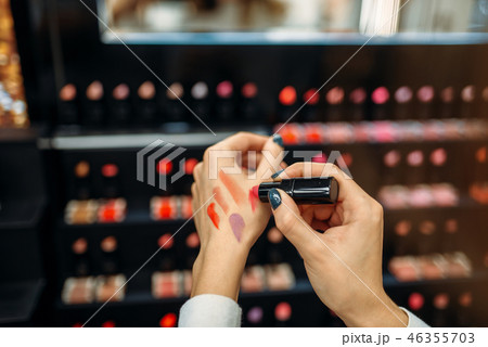 Female customer testing lipstick in make-up shop 46355703