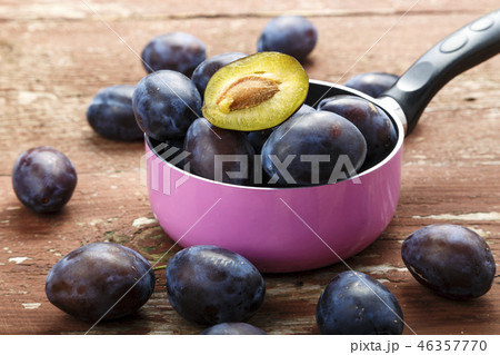 ripe plums in a saucepan 46357770