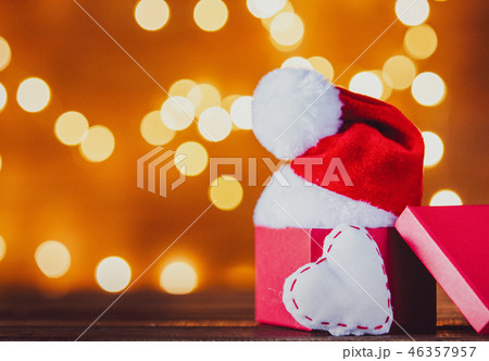 Christmas gift box and Santa Claus hat with heart shape Christmas gift box and Santa Claus hat with heart shape 46357957
