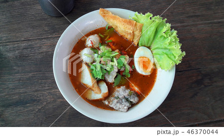 Spicy noodle meat soup serve in white bowl 46370044