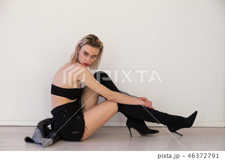 beautiful fashionable woman blonde in black boots with heel beautiful fashionable woman blonde in black boots with heel 46372791