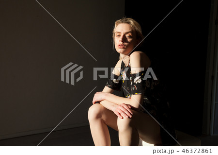beautiful fashionable woman blonde in dress with flowers on the street beautiful fashionable woman blonde in dress with flowers on the street 46372861