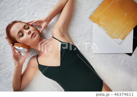 the image of resting sexy woman listening to vinyl 46374611