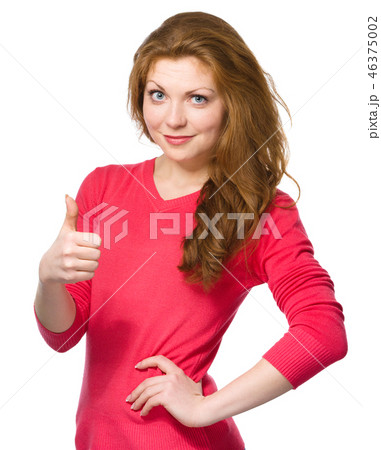 Woman is showing thumb up gesture Woman is showing thumb up gesture 46375002