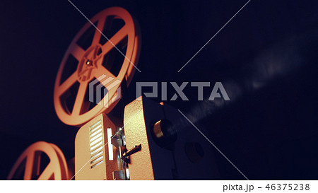 Vintage objects, cinematograph concept. Retro film projector playing in the dark room. Old-fashioned 46375238