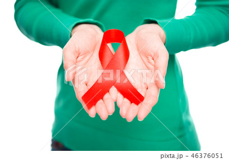 Woman is holding the red awareness ribbon Woman is holding the red awareness ribbon 46376051