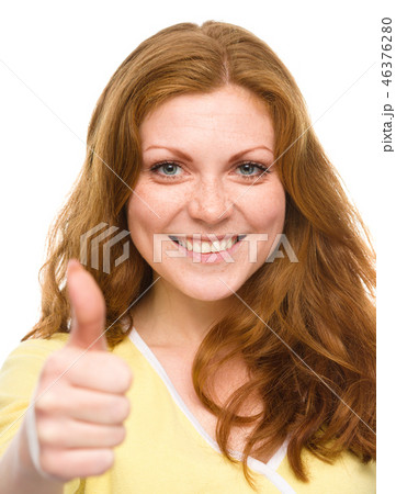 Woman is showing thumb up gesture 46376280