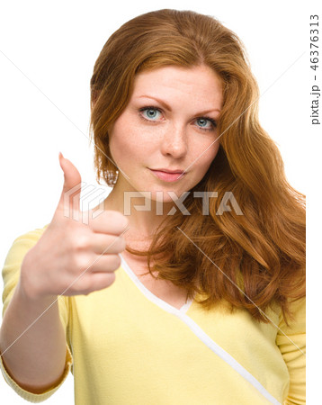 Woman is showing thumb up gesture 46376313
