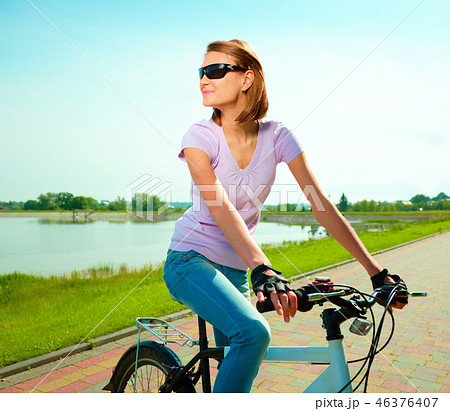 Young woman is sitting on her bicycle 46376407