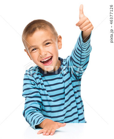 Little boy is showing thumb up sign 46377126