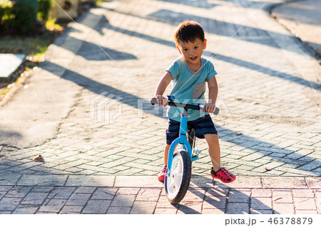 Asian boy ride balance bicycle in park 46378879