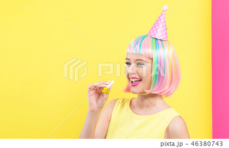 Woman in a wig with party accessories Woman in a wig with party accessories 46380743