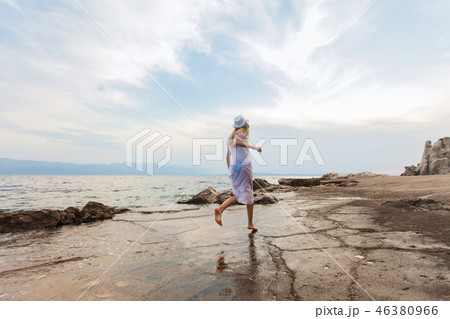 Beautiful running woman near the sea outdoors in the summer Beautiful running woman near the sea outdoors in the summer 46380966