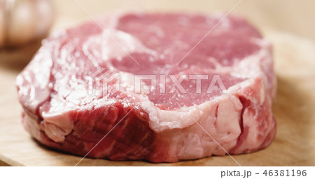 Closeup   of raw rib eye steak on board 46381196