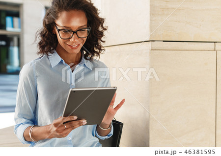 Young woman wearing eyeglasses reading  46381595