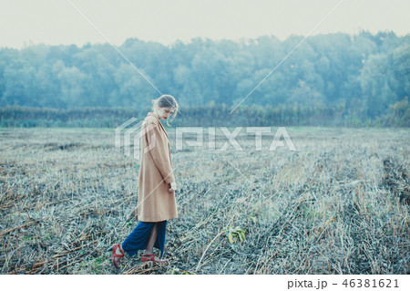 Lonely girl on a walk in the autumn field 46381621