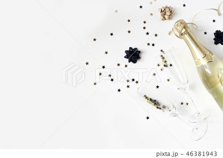 Happy New Year composition. Champagne wine bottle and glasses with golden confetti stars isolated on 46381943
