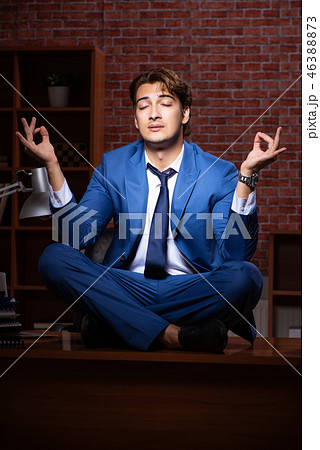 Young businessman working in the office at night Young businessman working in the office at night 46388873