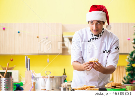 Young chef husband working in kitchen at Christmas eve Young chef husband working in kitchen at Christmas eve 46389851