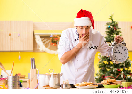 Young chef husband working in kitchen at Christmas eve Young chef husband working in kitchen at Christmas eve 46389852