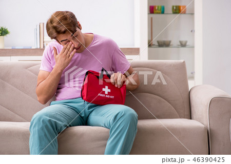 Sick man at home with first aid kit 46390425