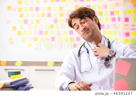 Male doctor with many conflicting prioritites  46391207