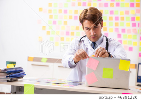 Male doctor with many conflicting prioritites  46391220