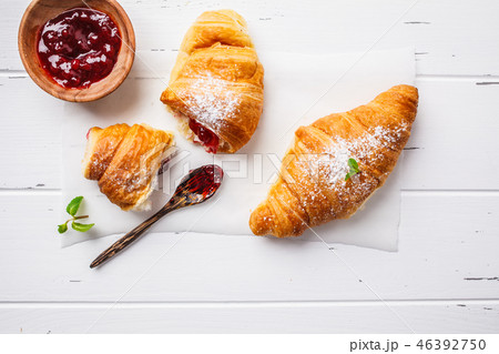 Croissants with berry jam on white background. Croissants with berry jam on white background. 46392750
