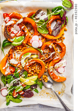 Baked pumpkin with chickpeas on a baking sheet 46392980