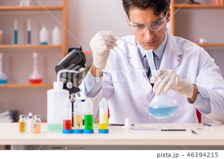 Young handsome biochemist working in the lab Young handsome biochemist working in the lab 46394215
