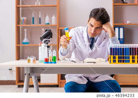 Young handsome biochemist working in the lab Young handsome biochemist working in the lab 46394233