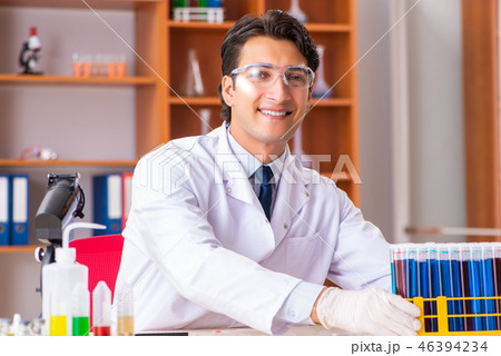 Young handsome biochemist working in the lab   46394234