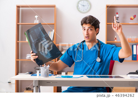 Young handsome doctor radiologyst working in clinic Young handsome doctor radiologyst working in clinic 46394262