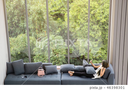 Woman laying on sofa at home. Woman laying on sofa at home. 46398301